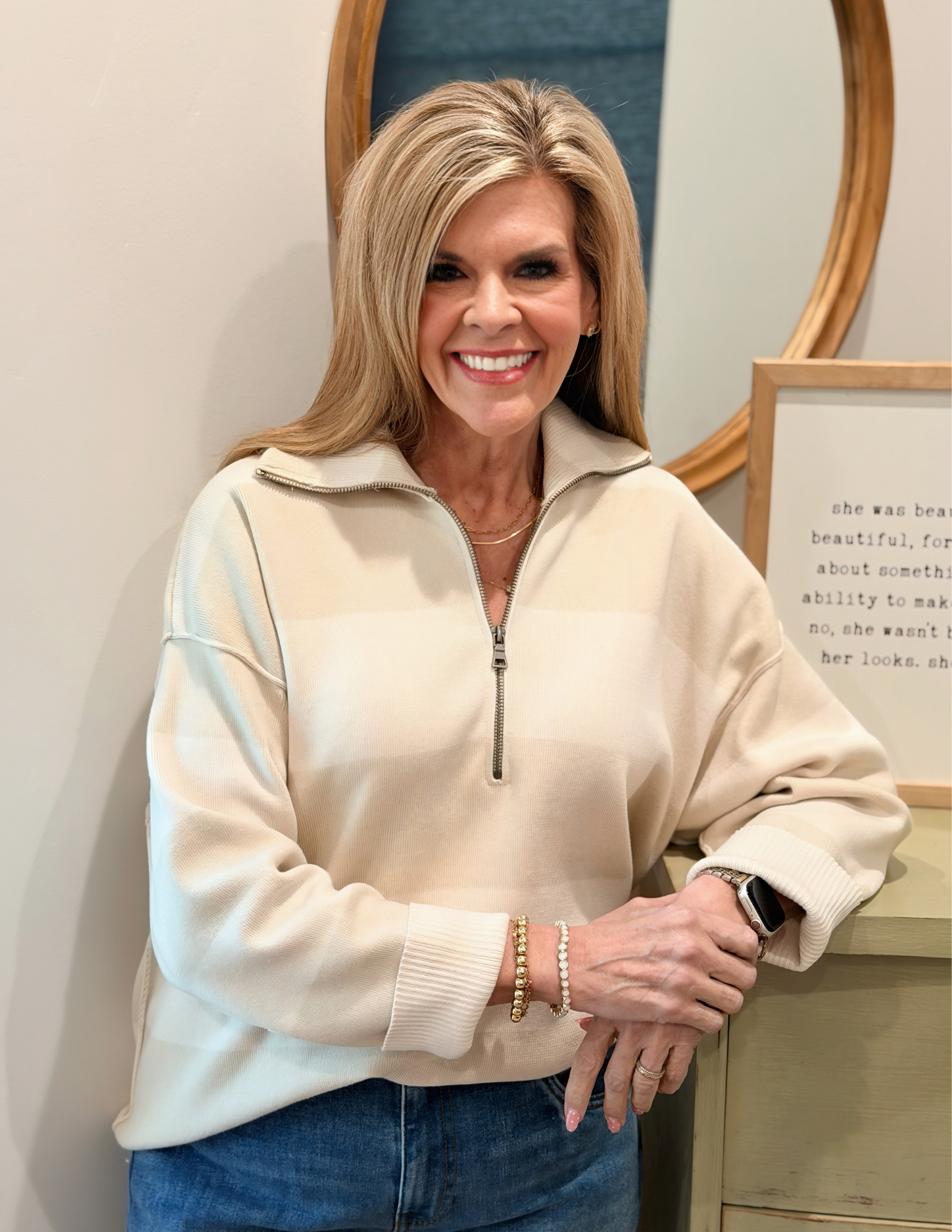 Woman wearing a white striped sweater against a plain background